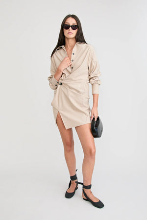 Shop the Zena Twist Dress Beige by Pfeiffer at Girls with Gems. A pinstripe shirt dress with signature twists, waist tucks.