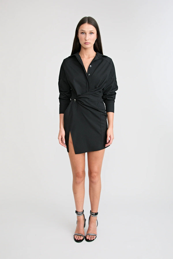 Shop the Zena Twist Dress Black by Pfeiffer at Girls with Gems. A pinstripe shirt dress with signature twists, waist tucks, and an asymmetric hem.