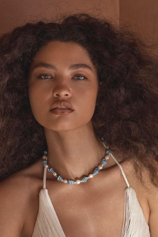 Siena Necklace by Amber Sceats – handcrafted in Italy with 24K gold plating, ceramic shells, and freshwater pearls for refined coastal elegance.
