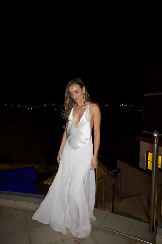 Sneaky Link Gia V-Neck Maxi Dress White, a flowy ivory maxi with deep V-neckline and single strap, perfect for weddings or elegant summer occasions.