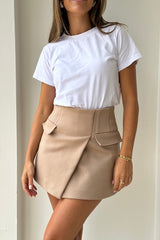 Sneaky Mini Skirt Latte by Sneaky Link – A-line high-waisted mini in bonded suiting with boned waist and mock pockets for chic all-day wear.