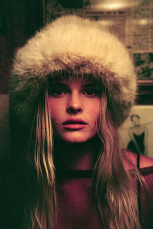 Snuggle Bucket Almond by Lack of Color, a faux fur bucket hat with turnback brim and silky lining. Perfect for cozy winter styling.