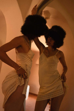 Snuggle Bucket Black by Lack of Color, a faux fur bucket hat with turnback brim and silky lining. Perfect for cozy winter styling.