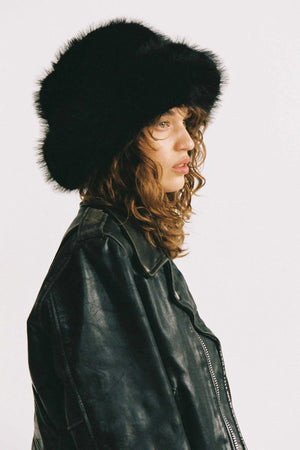 Snuggle Bucket Black by Lack of Color, a faux fur bucket hat with turnback brim and silky lining. Perfect for cozy winter styling.