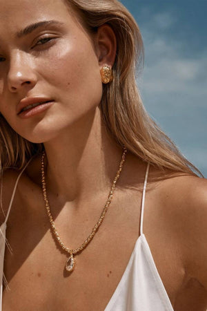 Sofian Necklace by Amber Sceats - gold necklace with clear quartz pendant and crushed beads, designed for bold elevated styling.