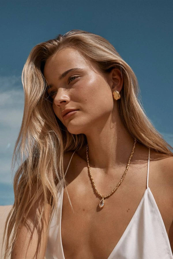 Sofian Necklace by Amber Sceats - gold necklace with clear quartz pendant and crushed beads, designed for bold elevated styling.