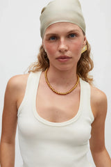 Sol Necklace Gold by Heaven Mayhem – polished gold bead necklace with signature S-clasp for layering.