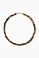 Sol Necklace Gold by Heaven Mayhem – polished gold beaded necklace with signature S clasp closure.