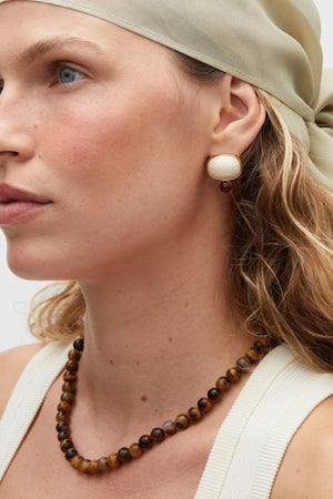 Sol Necklace Gold by Heaven Mayhem – polished gold beaded necklace with signature S clasp closure.