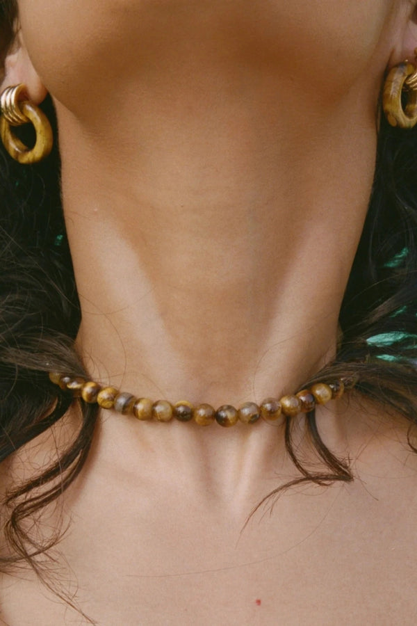 Sol Necklace Gold by Heaven Mayhem – polished gold beaded necklace with signature S clasp closure.