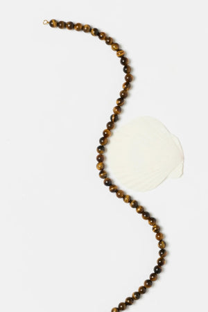 Sol Necklace Gold by Heaven Mayhem – polished gold beaded necklace with signature S clasp closure.