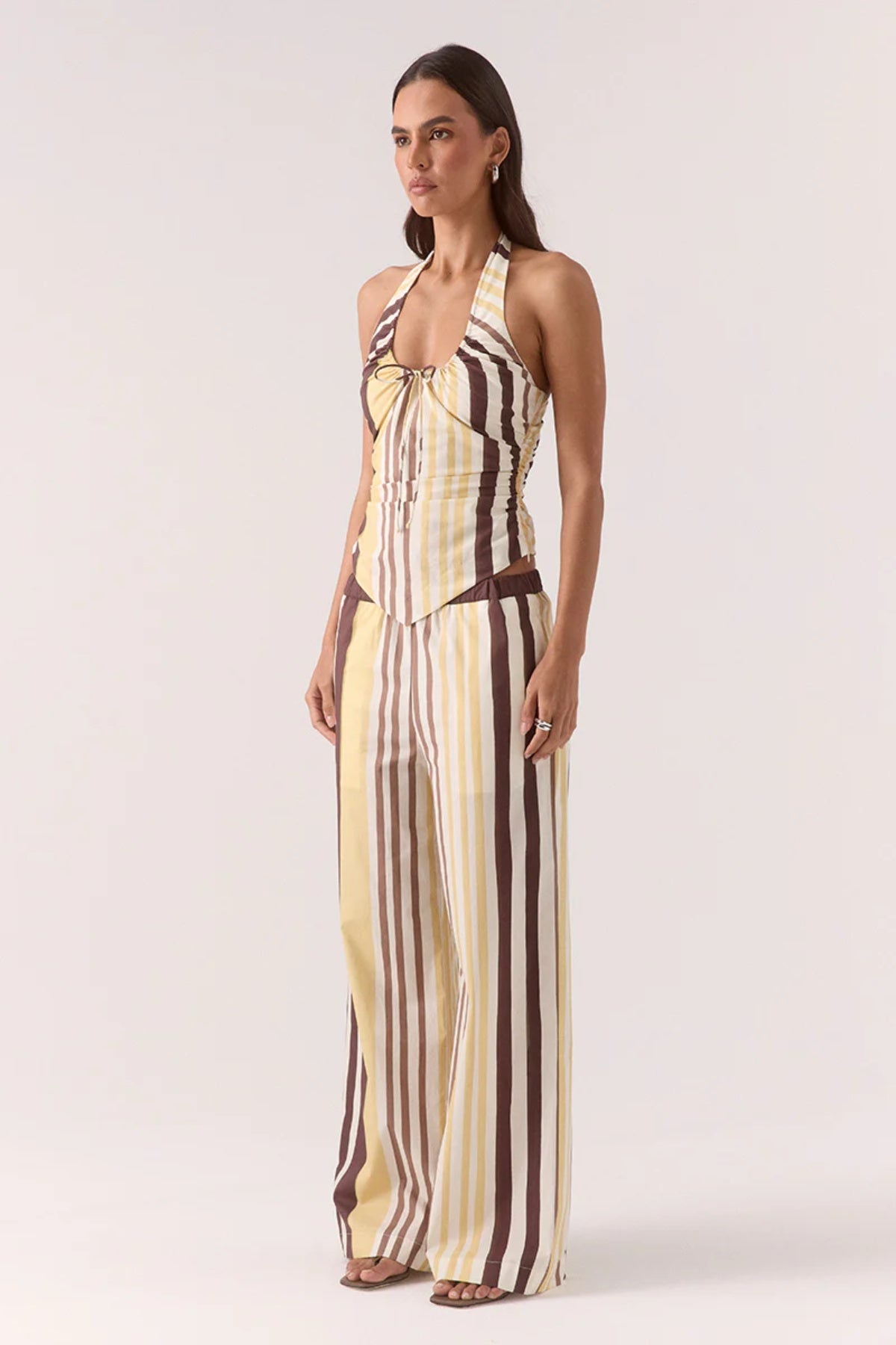 Sonali Top Banoffee by Sovere, a printed halter top with adjustable ties and a V-shaped hem for modern summer styling.