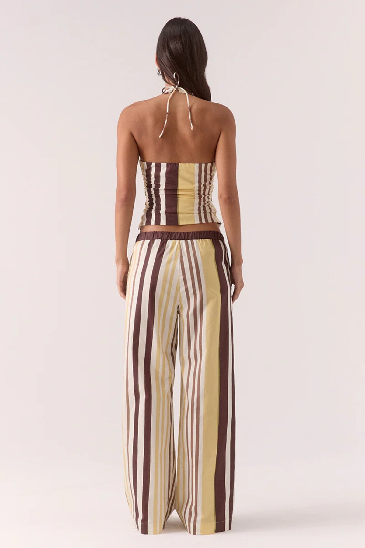 Sonali Top Banoffee by Sovere, a printed halter top with adjustable ties and a V-shaped hem for modern summer styling.