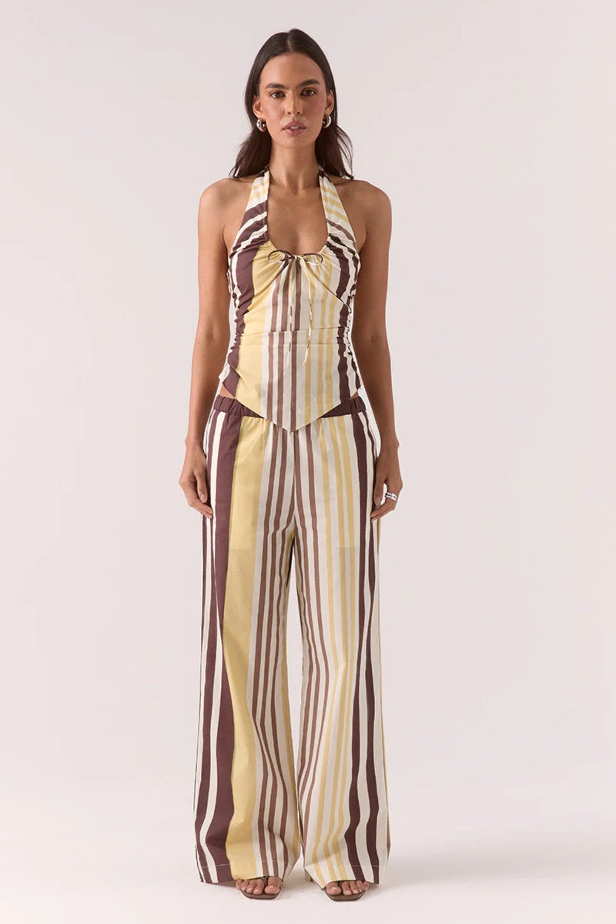 Sonali Top Banoffee by Sovere, a printed halter top with adjustable ties and a V-shaped hem for modern summer styling.