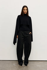 Sorella Poncho Black by Bayse – a draped knit poncho with mock neckline and relaxed fit. Perfect for layered styling.