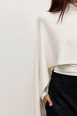 Sorella Poncho Ivory by Bayse – soft draped poncho with mock neckline and fluid layered silhouette.