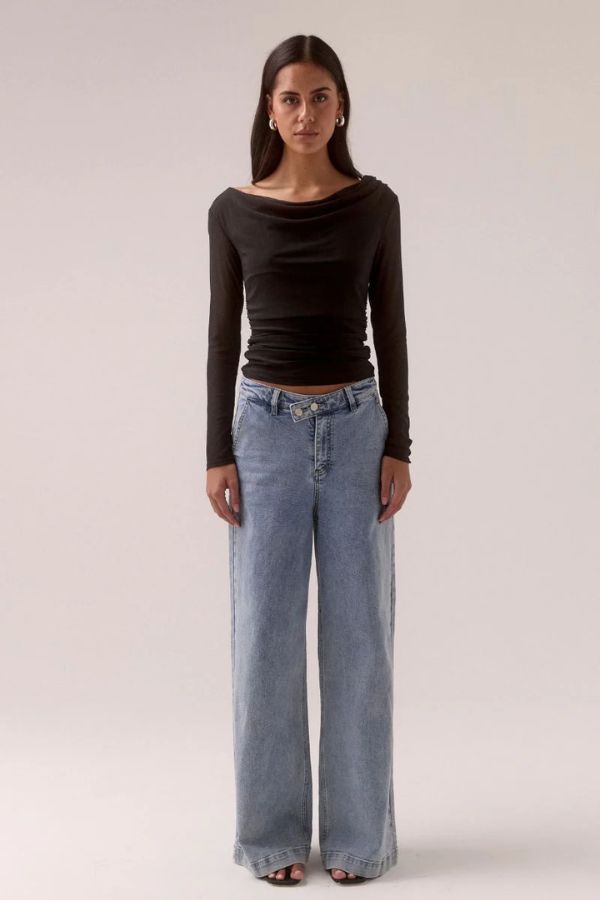 Sovere Myriad Cowl Long Sleeve in Black, a sleek fitted top with an off-shoulder cowl neckline, side gathers, and stretch mesh for a chic, modern look.