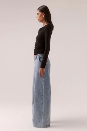 Sovere Myriad Cowl Long Sleeve in Black, a sleek fitted top with an off-shoulder cowl neckline, side gathers, and stretch mesh for a chic, modern look.