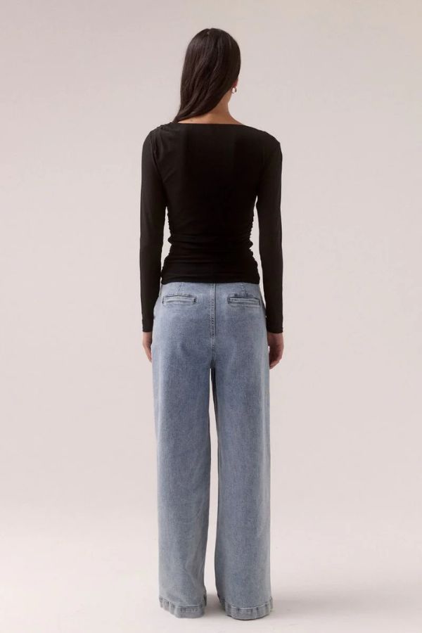 Sovere Myriad Cowl Long Sleeve in Black, a sleek fitted top with an off-shoulder cowl neckline, side gathers, and stretch mesh for a chic, modern look.