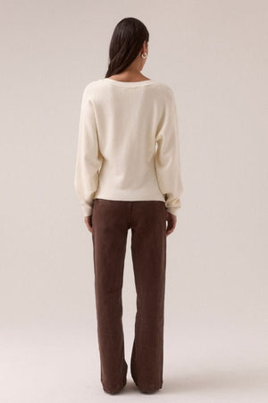 Sentiment Knit Cardi Chalk by Sovere, relaxed V-neck knit with wide-to-narrow sleeves and fitted waist. Perfect for layering with modern ease.