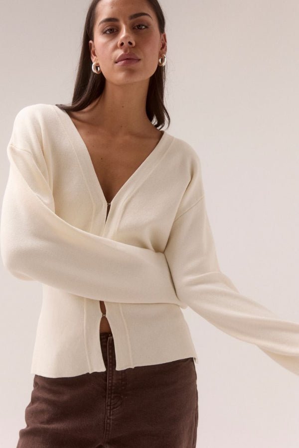Sentiment Knit Cardi Chalk by Sovere, relaxed V-neck knit with wide-to-narrow sleeves and fitted waist. Perfect for layering with modern ease.