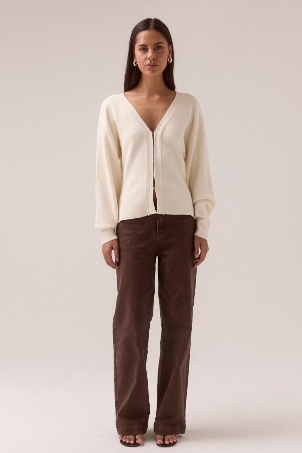 Sentiment Knit Cardi Chalk by Sovere, relaxed V-neck knit with wide-to-narrow sleeves and fitted waist. Perfect for layering with modern ease.