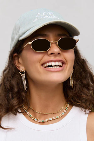 Starburst Gold Earrings by Arms of Eve, bold star-shaped drops with sparkling zircon stones and tassel chains that radiate elegance and edge