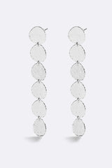 Sunset Hour Earrings Silver by Emma Pills - long silver drop earrings with hammered texture, designed for a bold statement look.