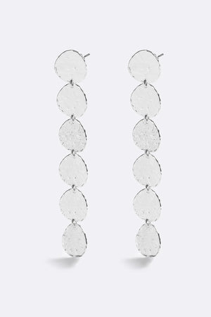 Sunset Hour Earrings Silver by Emma Pills - long silver drop earrings with hammered texture, designed for a bold statement look.