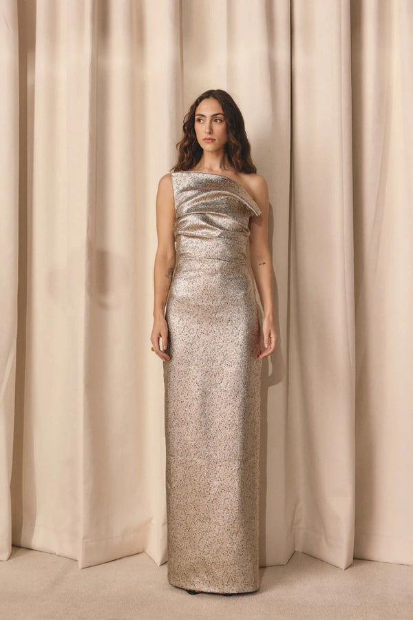 Tacoma Dress by Tojhà, a metallic champagne strapless gown with fold-over neckline, side tucks, and back split for sculptural elegance.