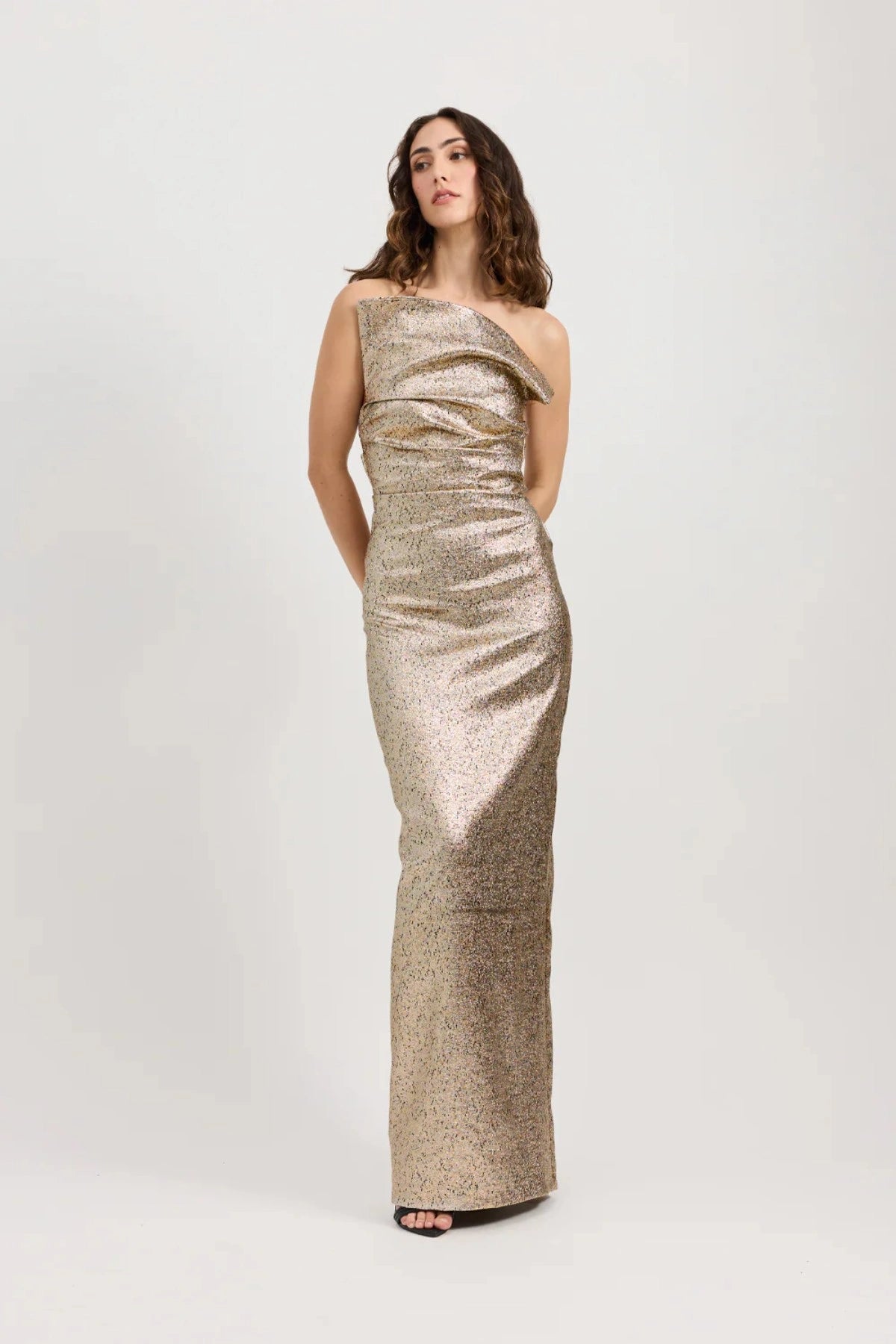 Tacoma Dress by Tojhà, a metallic champagne strapless gown with fold-over neckline, side tucks, and back split for sculptural elegance.