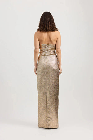Tacoma Dress by Tojhà, a metallic champagne strapless gown with fold-over neckline, side tucks, and back split for sculptural elegance.