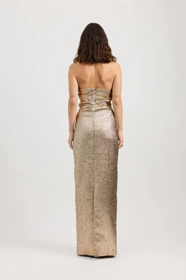 Tacoma Dress by Tojhà, a metallic champagne strapless gown with fold-over neckline, side tucks, and back split for sculptural elegance.