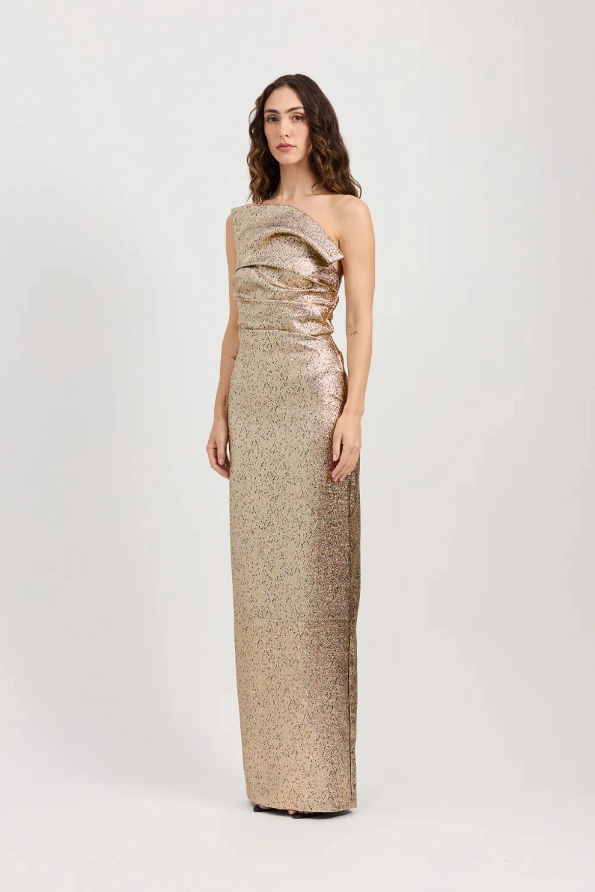 Tacoma Dress by Tojhà, a metallic champagne strapless gown with fold-over neckline, side tucks, and back split for sculptural elegance.