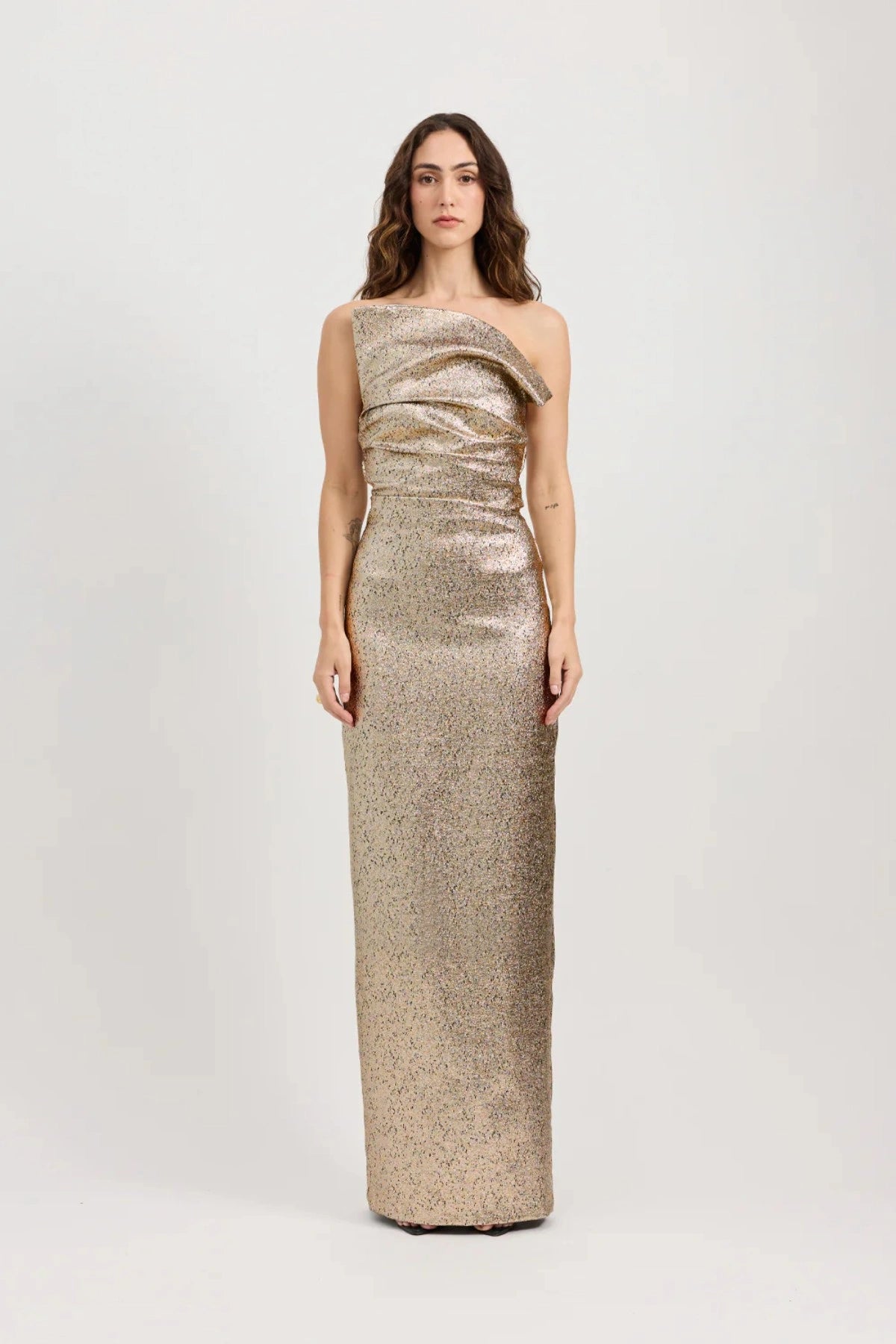 Tacoma Dress by Tojhà, a metallic champagne strapless gown with fold-over neckline, side tucks, and back split for sculptural elegance.