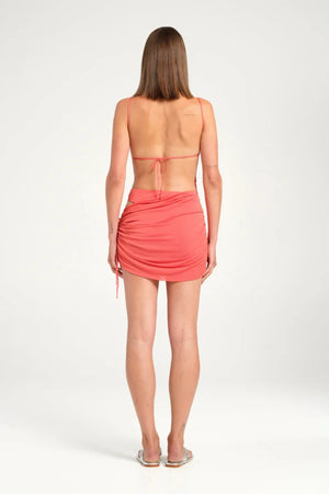 Tanner Mini Dress Watermelon by Benni, mini with straight neckline, open back and cowl skirt, perfect for parties or summer nights.