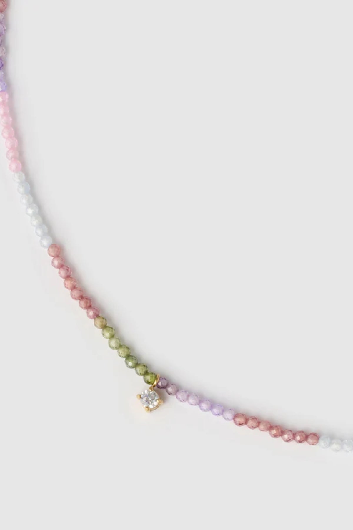 Taylor Necklace by Arms of Eve, delicate gold chain with multi-coloured zircon stones and charm for a playful, twinkling touch of elegance.