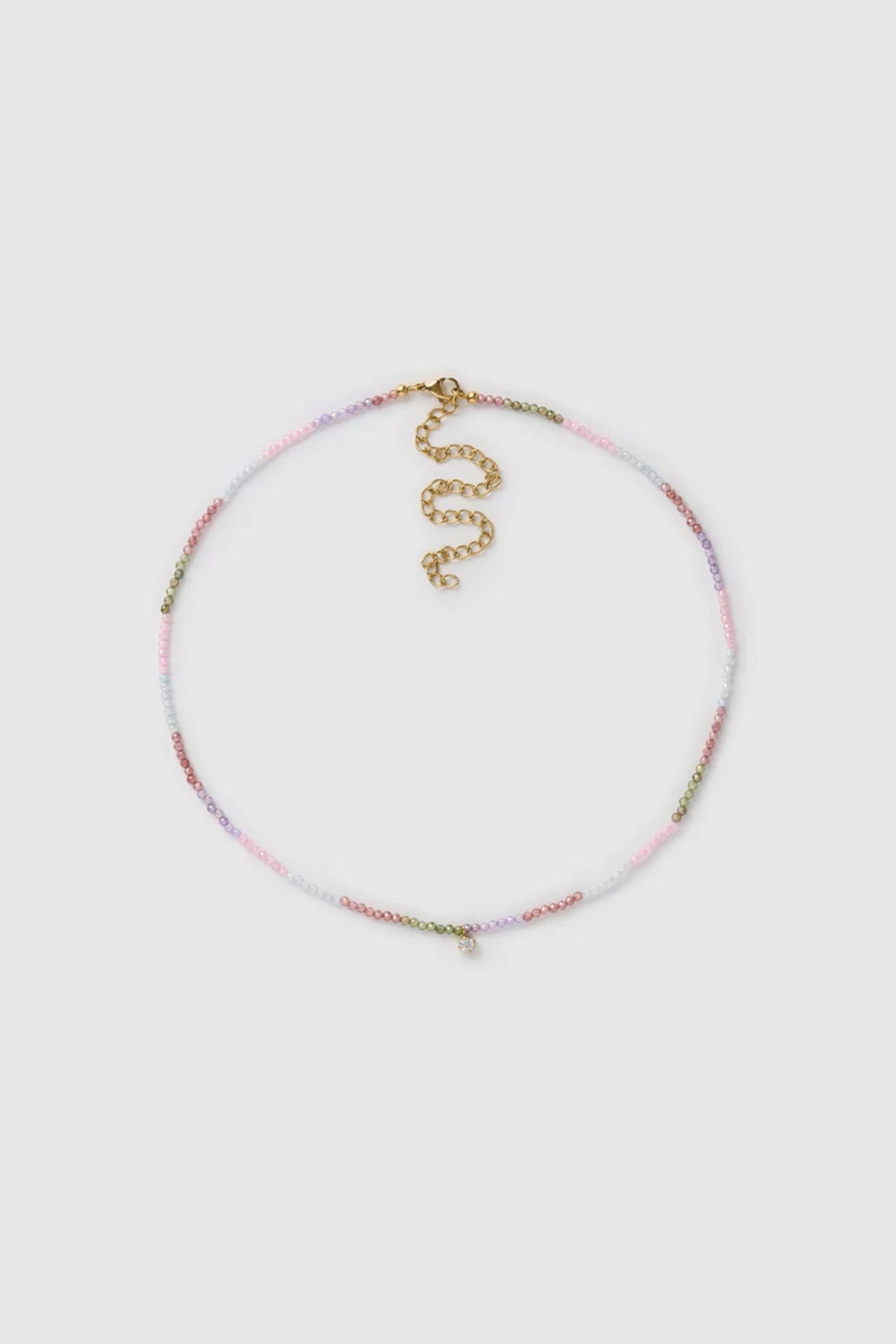 Taylor Necklace by Arms of Eve, delicate gold chain with multi-coloured zircon stones and charm for a playful, twinkling touch of elegance.