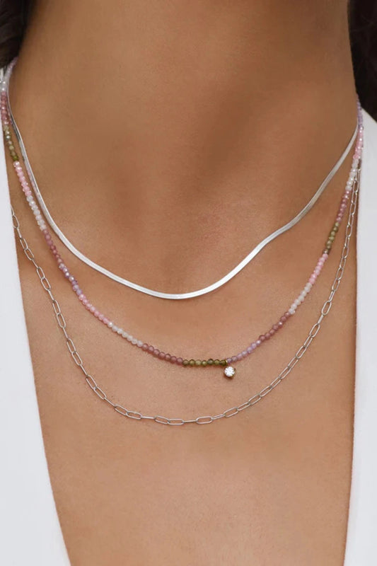 Taylor Necklace by Arms of Eve, delicate gold chain with multi-coloured zircon stones and charm for a playful, twinkling touch of elegance.