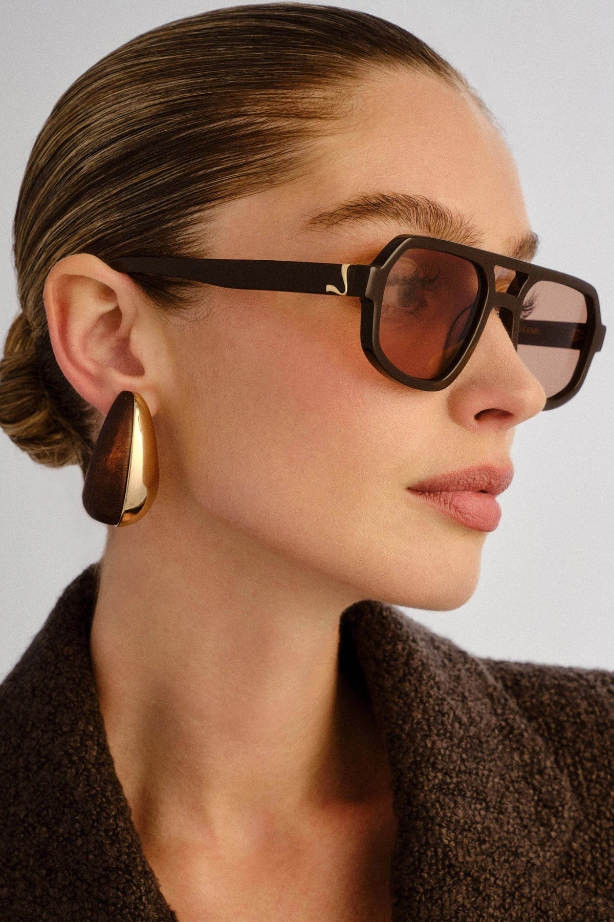 The Banks Sunglasses Dark Chocolate by Luv Lou – oversized aviator with gold hardware and brown tint lenses in premium dark chocolate finish.

