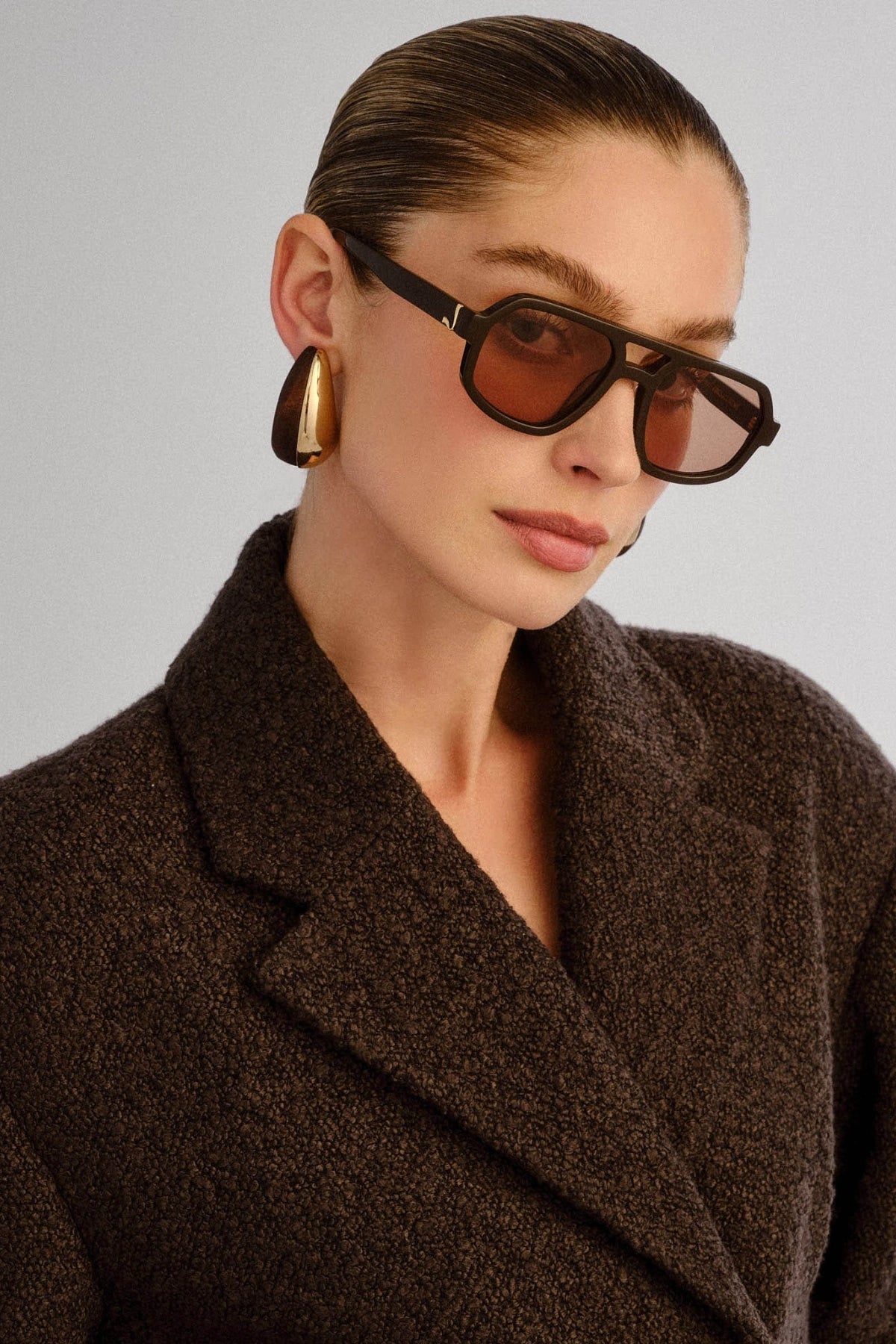 The Banks Sunglasses Dark Chocolate by Luv Lou – oversized aviator with gold hardware and brown tint lenses in premium dark chocolate finish.
