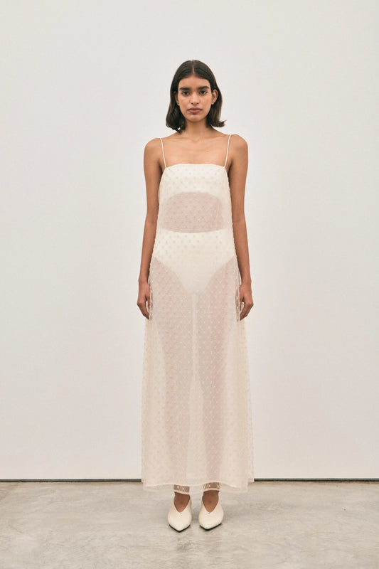 The Camilla Dress Beaded Ivory by Solaqua – sheer beaded maxi dress with geometric embellishments and elegant drape.