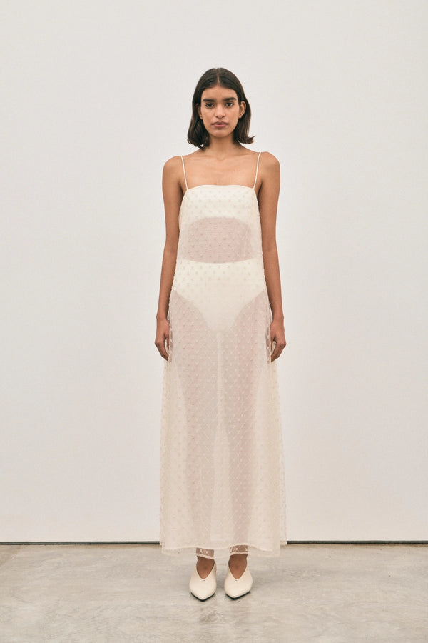 The Camilla Dress Beaded Ivory by Solaqua – sheer beaded maxi dress with geometric embellishments and elegant drape.