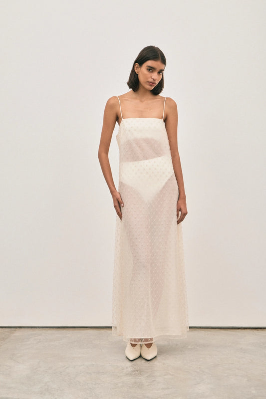 The Camilla Dress Beaded Ivory by Solaqua – sheer beaded maxi dress with geometric embellishments and elegant drape.