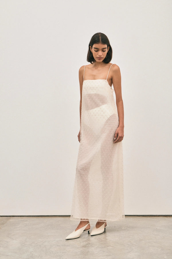 The Camilla Dress Beaded Ivory by Solaqua – sheer beaded maxi dress with geometric embellishments and elegant drape.