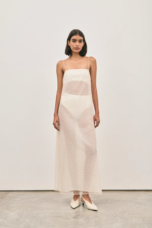 The Camilla Dress Beaded Ivory by Solaqua – sheer beaded maxi dress with geometric embellishments and elegant drape.