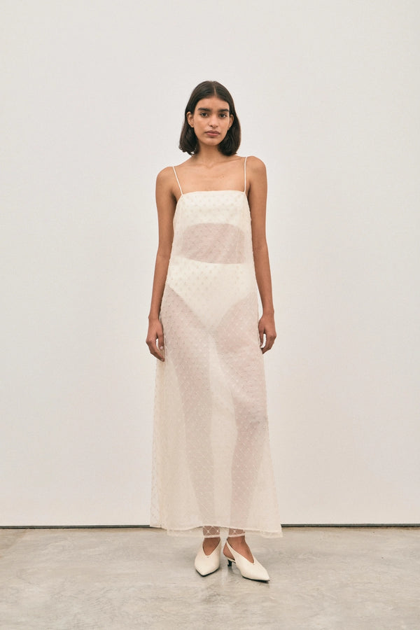 The Camilla Dress Beaded Ivory by Solaqua – sheer beaded maxi dress with geometric embellishments and elegant drape.