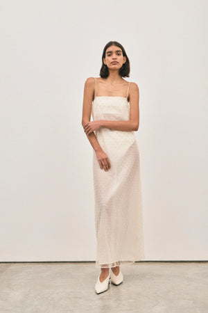 The Camilla Dress Beaded Ivory by Solaqua – sheer beaded maxi dress with geometric embellishments and elegant drape.