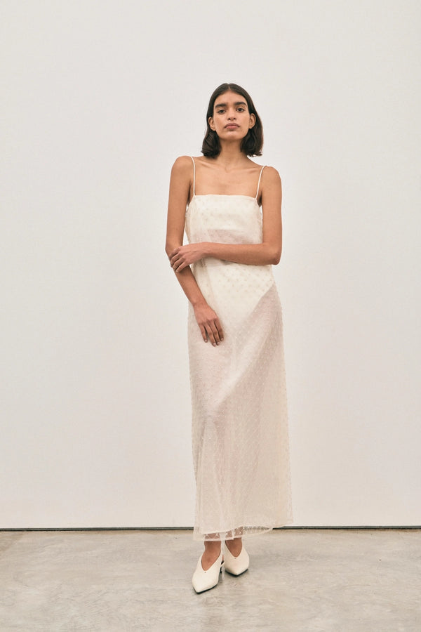 The Camilla Dress Beaded Ivory by Solaqua – sheer beaded maxi dress with geometric embellishments and elegant drape.