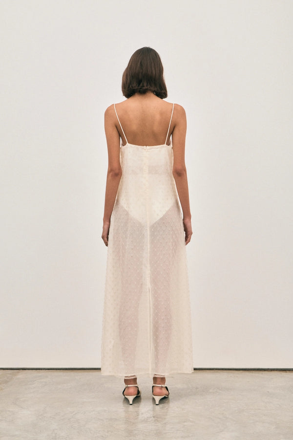 The Camilla Dress Beaded Ivory by Solaqua – sheer beaded maxi dress with geometric embellishments and elegant drape.
